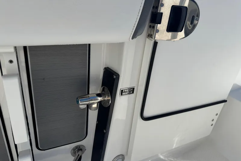 Slide: The Image of 2021 Blackfin 252 CC boat detail with fresh water access and sleek design. - 12