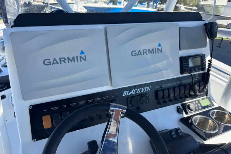 Slide: The Image of 2021 Blackfin 252 CC boat dashboard with Garmin displays and controls. - 14