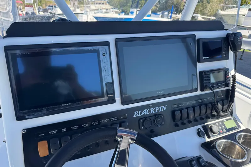 Slide: The Image of 2021 Blackfin 252 CC boat dashboard with Garmin displays and control panel. - 15
