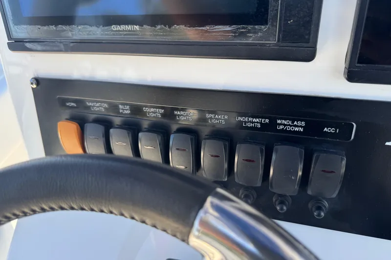Slide: The Image of Control panel of 2021 Blackfin 252 CC boat with labeled switches and Garmin display. - 18