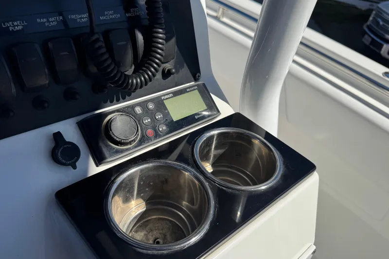 Slide: The Image of Control panel of 2021 Blackfin 252 CC boat with cup holders and audio system. - 19
