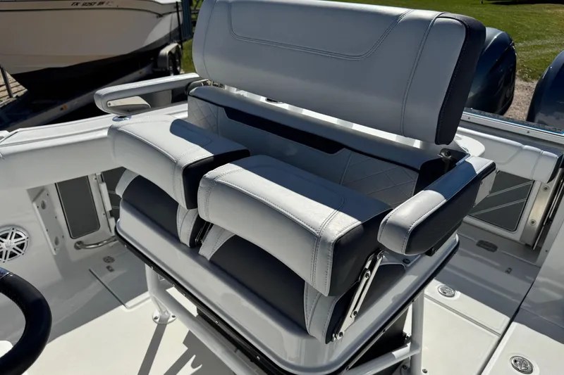 Slide: The Image of 2021 Blackfin 252 CC boat seating with cushioned armrests and sleek design. - 21