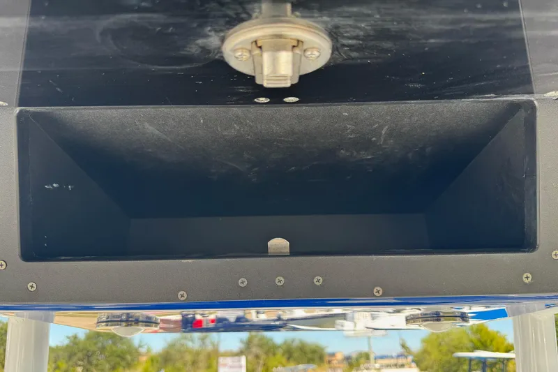 Slide: The Image of Storage compartment on a 2021 Blackfin 252 CC boat, featuring a secure latch. - 23