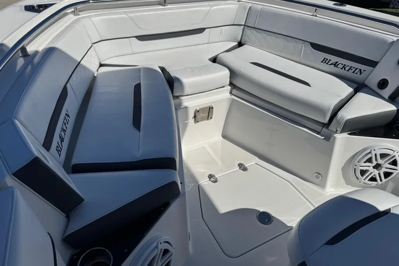 Slide: The Image of 2021 Blackfin 252 CC boat interior with cushioned seating and speaker system. - 24
