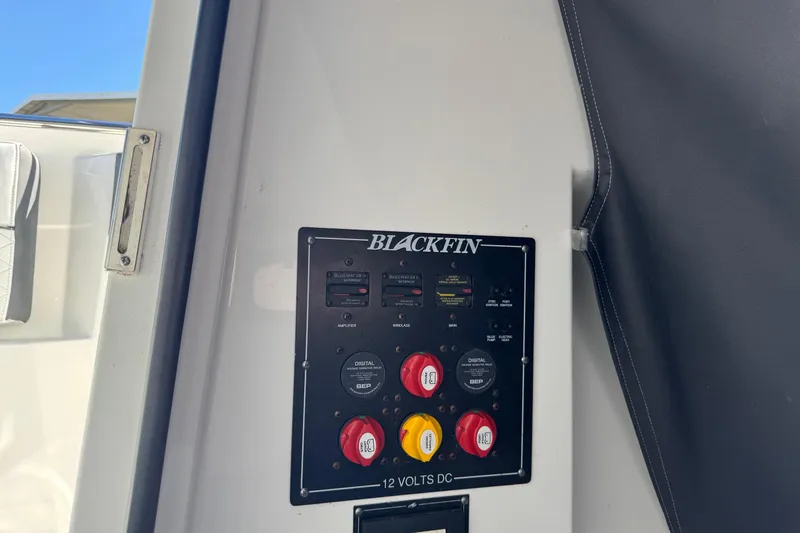 Slide: The Image of Control panel of a 2021 Blackfin 252 CC boat, featuring switches and dials. - 28