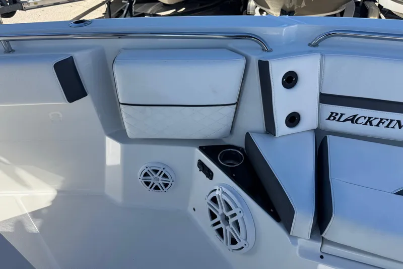 Slide: The Image of 2021 Blackfin 252 CC boat interior with seating, speakers, and cup holder. - 29