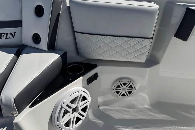 Slide: The Image of 2021 Blackfin 252 CC boat interior with cushioned seating, speakers, and cup holder. - 30