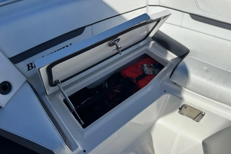 Slide: The Image of 2021 Blackfin 252 CC boat storage compartment with safety gear inside. - 35
