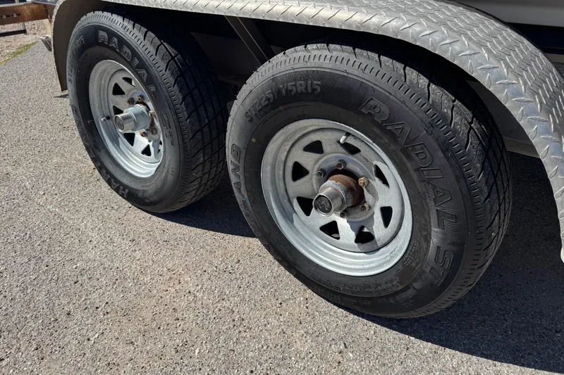 Slide: The Image of Trailer wheels with radial tires on a 2021 Blackfin 252 CC boat trailer. - 41