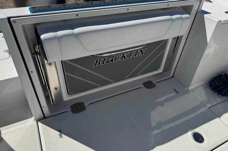 Slide: The Image of 2021 Blackfin 252 CC boat interior with foldable seat and logo. - 5