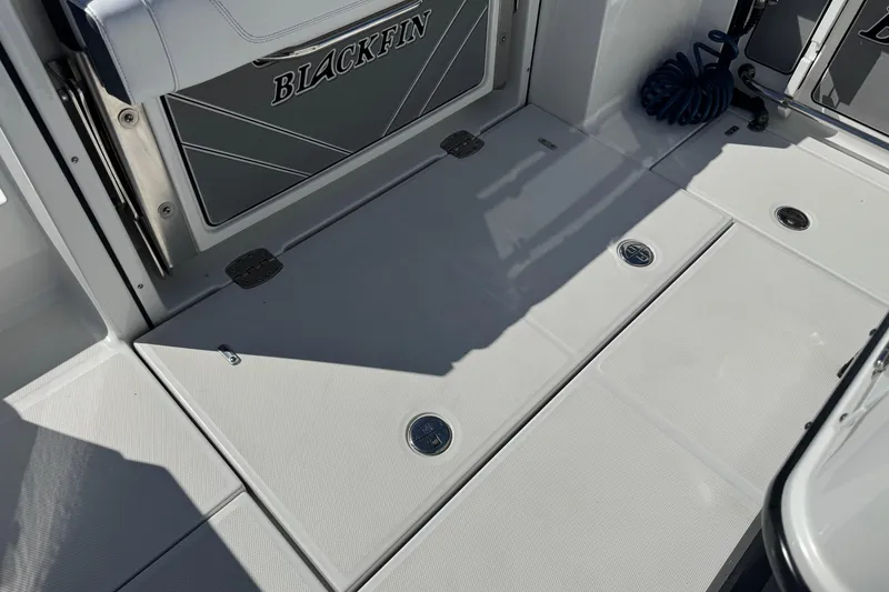Slide: The Image of 2021 Blackfin 252 CC boat deck with storage compartments and coiled rope. - 7