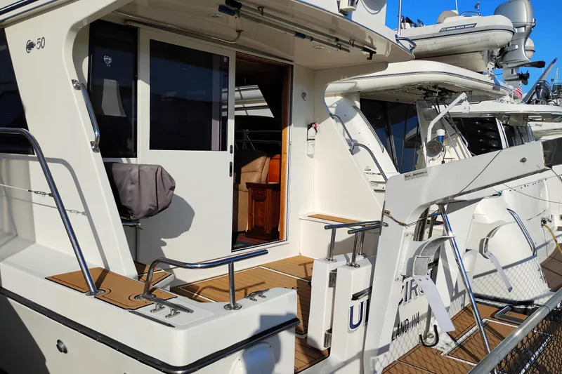 Slide: The Image of 2002 Canoe Cove 50 Pilothouse Motor Yacht docked, showcasing exterior and entryway. - 10