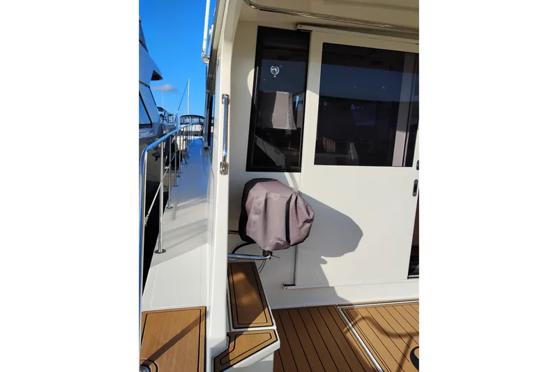 Slide: The Image of Canoe Cove 50 Pilothouse Motor Yacht 2002, side deck view with sliding door and railing. - 11