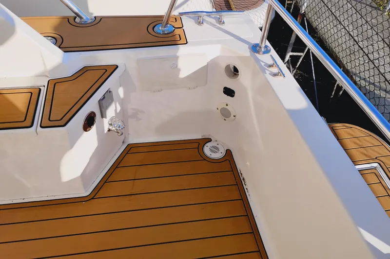 Slide: The Image of Canoe Cove 50 Pilothouse Motor Yacht 2002, featuring teak deck and stainless steel railings. - 12