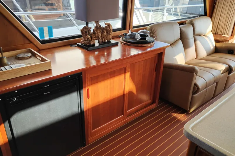 Slide: The Image of Interior of 2002 Canoe Cove 50 Pilothouse Motor Yacht with wood cabinetry and leather seating. - 18