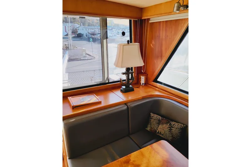 Slide: The Image of Interior of 2002 Canoe Cove 50 Pilothouse Motor Yacht with cozy seating and lamp. - 20
