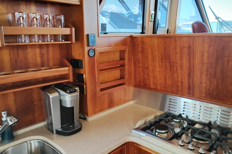 Slide: The Image of Luxurious kitchen in 2002 Canoe Cove 50 Pilothouse Motor Yacht with stove and coffee maker. - 24