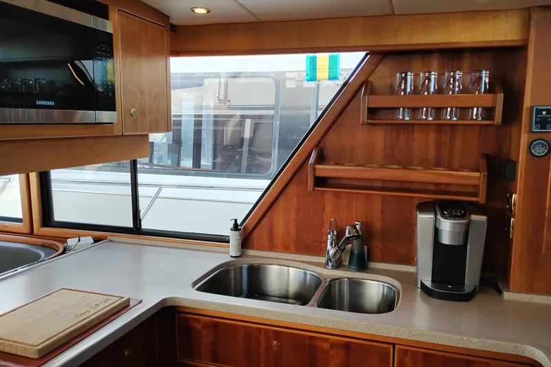Slide: The Image of Interior of 2002 Canoe Cove 50 Pilothouse Motor Yacht kitchen with sink and appliances. - 26