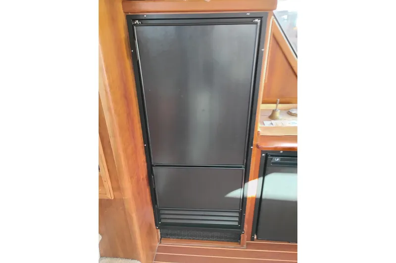 Slide: The Image of Black refrigerator in 2002 Canoe Cove 50 Pilothouse Motor Yacht interior. - 29