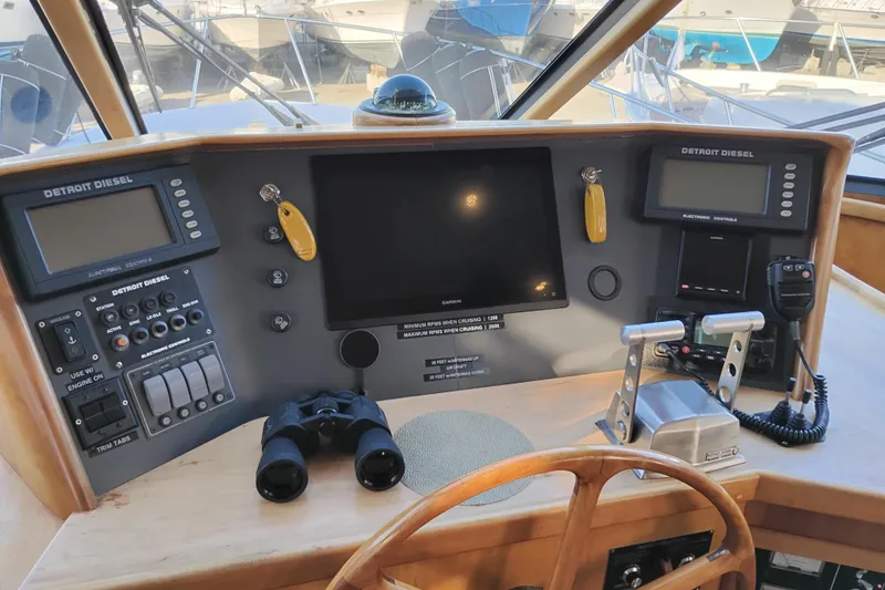 Slide: The Image of Pilothouse of 2002 Canoe Cove 50 Motor Yacht with navigation controls and Detroit Diesel displays. - 32
