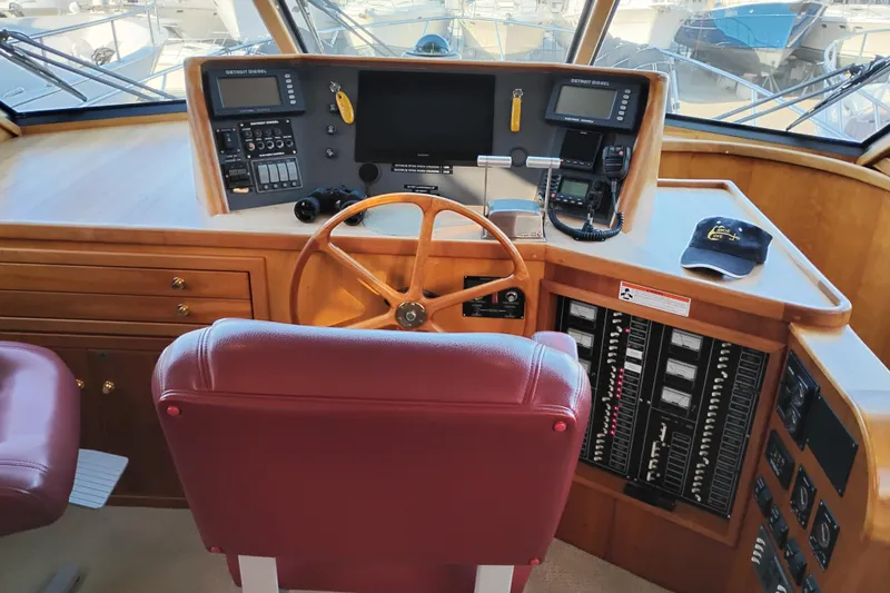 Slide: The Image of Pilothouse of 2002 Canoe Cove 50 Motor Yacht with steering wheel and control panel. - 33