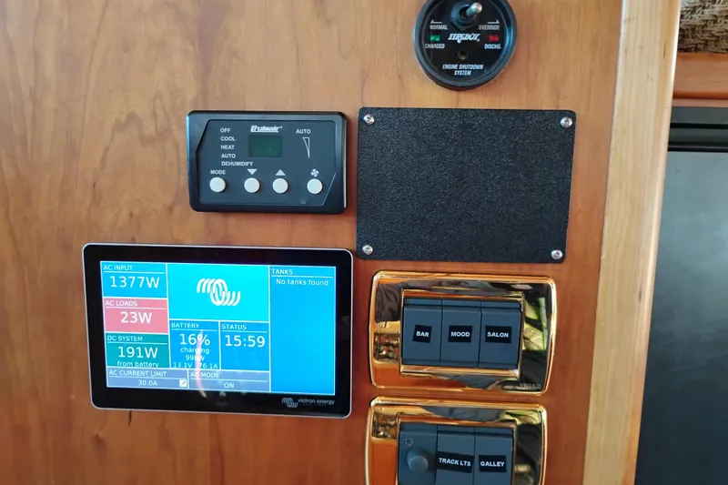 Slide: The Image of Control panel of a 2002 Canoe Cove 50 Pilothouse Motor Yacht displaying power and system settings. - 39