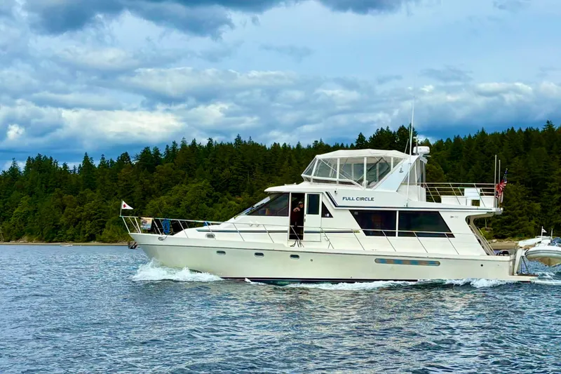 Slide: The Image of Canoe Cove 50 Pilothouse Motor Yacht cruising on a scenic lake, 2002 model. - 4