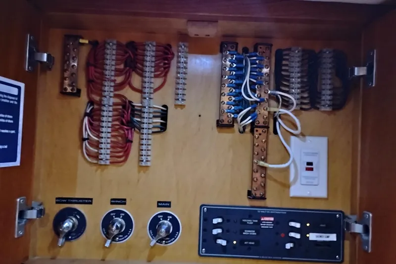 Slide: The Image of Electrical panel inside 2002 Canoe Cove 50 Pilothouse Motor Yacht, featuring wiring and switches. - 41