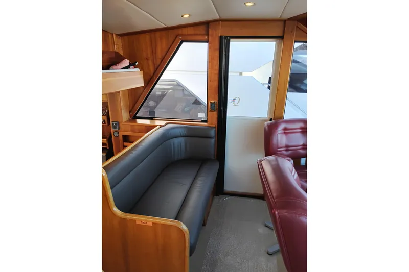 Slide: The Image of Interior of 2002 Canoe Cove 50 Pilothouse Motor Yacht with leather seating and wood paneling. - 42
