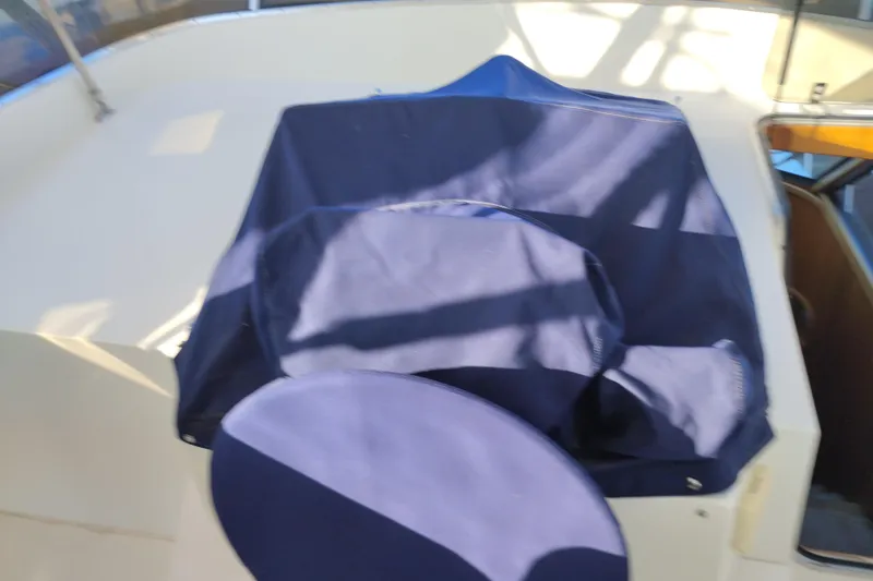 Slide: The Image of 2002 Canoe Cove 50 Pilothouse Motor Yacht helm covered with blue fabric. - 48