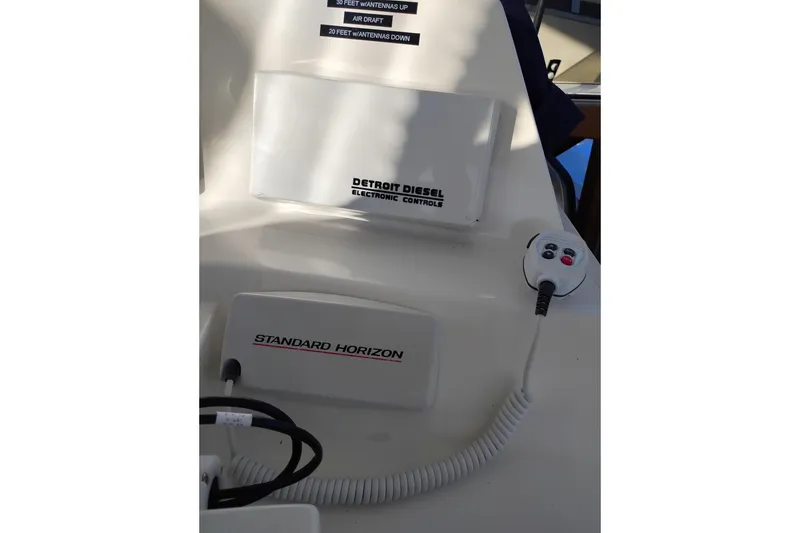 Slide: The Image of Control panel of a 2002 Canoe Cove 50 Pilothouse Motor Yacht with Detroit Diesel and Standard Horizon systems. - 52