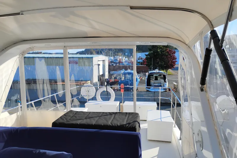 Slide: The Image of Interior view of 2002 Canoe Cove 50 Pilothouse Motor Yacht at marina. - 56