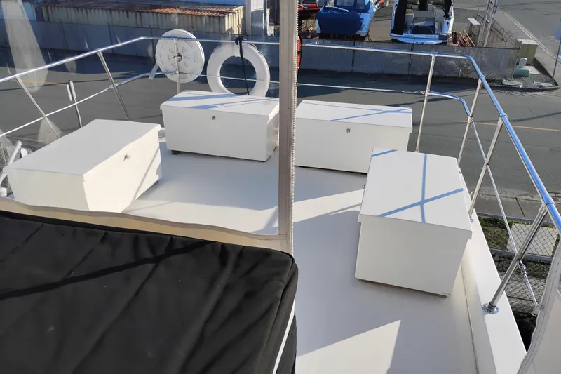 Slide: The Image of 2002 Canoe Cove 50 Pilothouse Motor Yacht deck with storage boxes and life ring. - 57