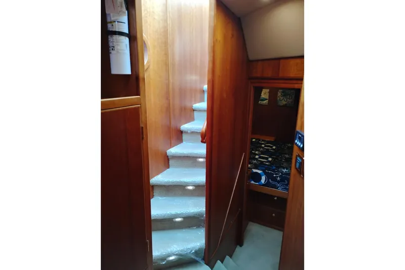 Slide: The Image of Interior of 2002 Canoe Cove 50 Pilothouse Motor Yacht with carpeted stairs and cozy cabin. - 61