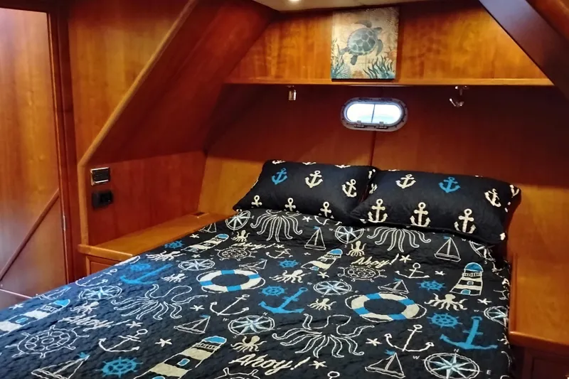 Slide: The Image of Cozy bedroom in 2002 Canoe Cove 50 Pilothouse Motor Yacht with nautical-themed bedding. - 63