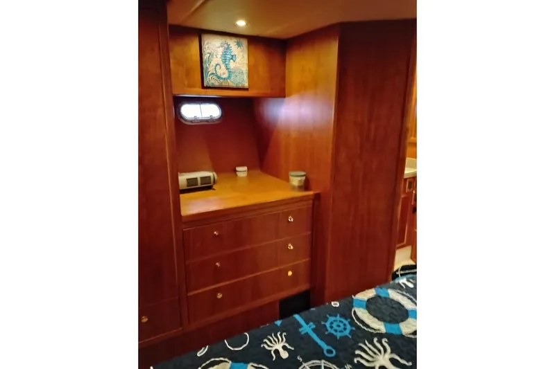 Slide: The Image of Interior of 2002 Canoe Cove 50 Pilothouse Motor Yacht with wooden cabinetry and nautical decor. - 64