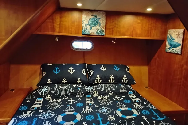 Slide: The Image of Cozy cabin bedroom in 2002 Canoe Cove 50 Pilothouse Motor Yacht with nautical-themed bedding. - 65
