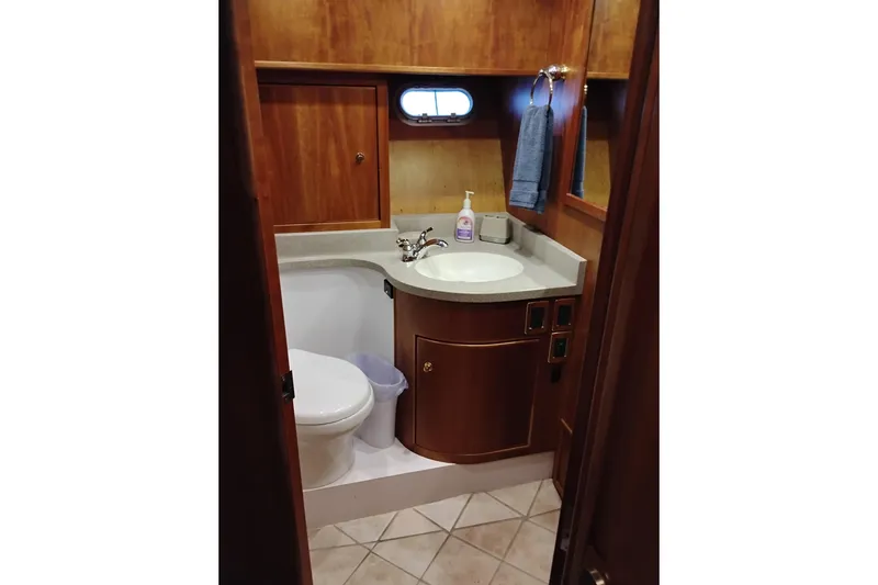 Slide: The Image of Bathroom interior of 2002 Canoe Cove 50 Pilothouse Motor Yacht, featuring wood cabinetry. - 68