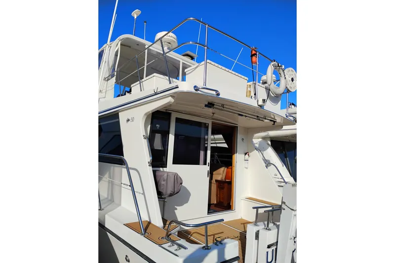 Slide: The Image of 2002 Canoe Cove 50 Pilothouse Motor Yacht with open cabin door and upper deck view. - 7