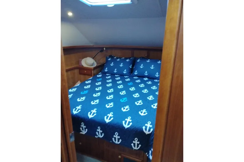 Slide: The Image of Cozy bedroom in 2002 Canoe Cove 50 Pilothouse Motor Yacht with nautical-themed bedding. - 71