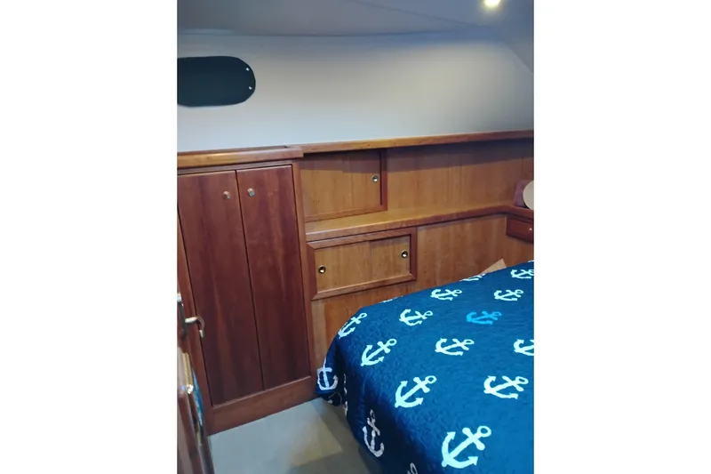 Slide: The Image of Interior cabin of 2002 Canoe Cove 50 Pilothouse Motor Yacht with anchor-themed bedding. - 73