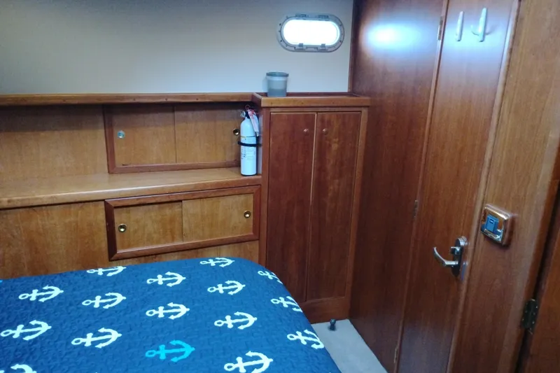 Slide: The Image of Interior cabin of 2002 Canoe Cove 50 Pilothouse Motor Yacht with wooden cabinetry. - 74