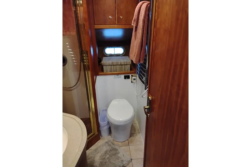 Slide: The Image of Luxurious bathroom in 2002 Canoe Cove 50 Pilothouse Motor Yacht, featuring elegant wood finishes. - 77