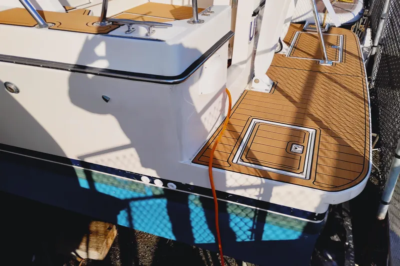 Slide: The Image of 2002 Canoe Cove 50 Pilothouse Motor Yacht with teak deck and railing details. - 8