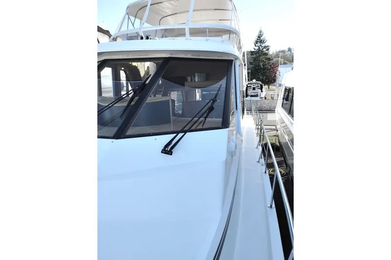 Slide: The Image of 2002 Canoe Cove 50 Pilothouse Motor Yacht, side view with clear blue sky. - 81