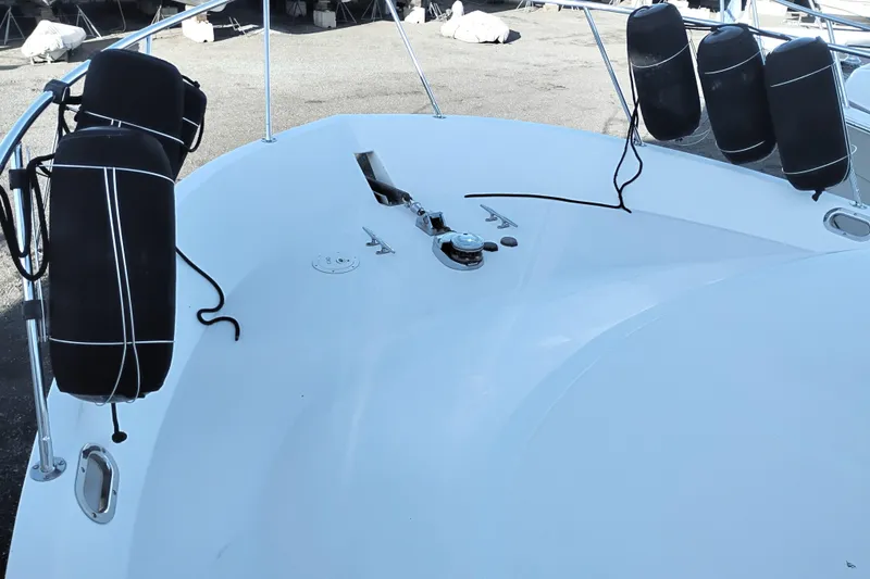 Slide: The Image of Bow of 2002 Canoe Cove 50 Pilothouse Motor Yacht with fenders and anchor equipment. - 82