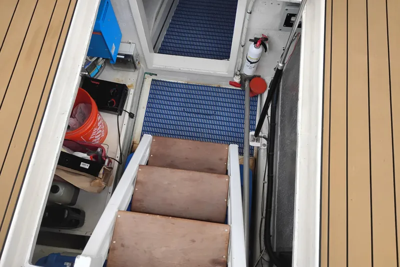 Slide: The Image of Engine room access of 2002 Canoe Cove 50 Pilothouse Motor Yacht with wooden steps and equipment. - 84