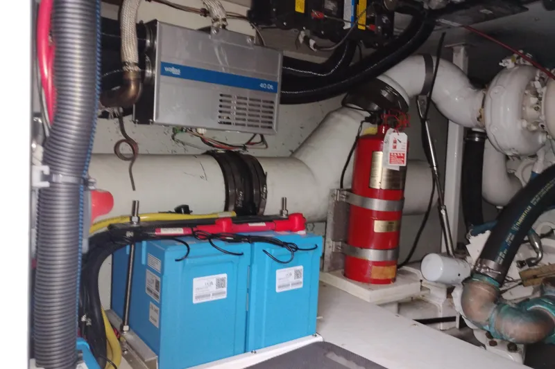 Slide: The Image of Engine room of 2002 Canoe Cove 50 Pilothouse Motor Yacht with batteries and fire extinguisher. - 87