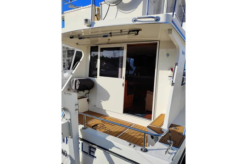 Slide: The Image of 2002 Canoe Cove 50 Pilothouse Motor Yacht, rear deck view with sliding door. - 9