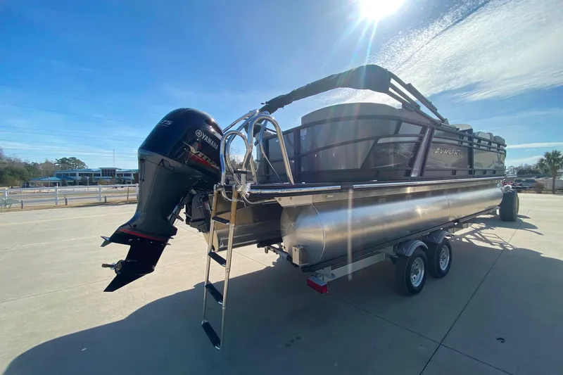 Slide: The Image of 2024 Starcraft SLS 3 pontoon boat with Yamaha outboard motor on a trailer. - 5